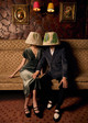 Christopher Farr Cloth lampshade collection featured in a marketing campaign, with lampshades styled on the heads of a couple at the Rivoli Bar, showcasing how our designs create a lifestyle. Photography by Sophia Spring.